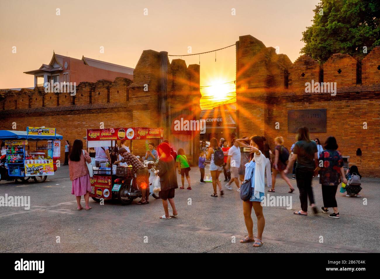 Un touriste posant pour un selfie devant la porte de Tha Phae au coucher du soleil, Chiang Mai, Thaïlande Banque D'Images Un touriste posant pour un selfie devant la porte de Tha Phae au coucher du soleil, Chiang Mai, Thaïlande Banque D'Images