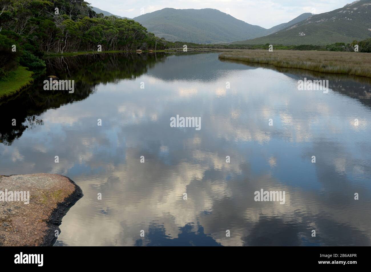 Ciel tôt le matin et Mt Ramsay reflétés dans les eaux vitreux de la rivière Tidal Banque D'Images