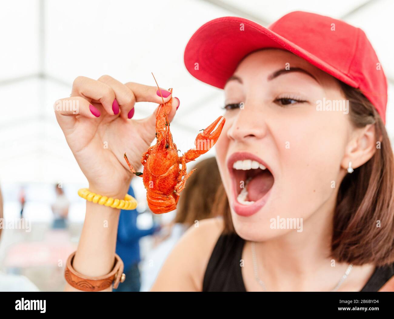 Jeune femme mangeant de délicieux écrevisses bouillies rouges ou du homard de la rivière à ramper. Cuisine locale et concept de fruits de mer Banque D'Images