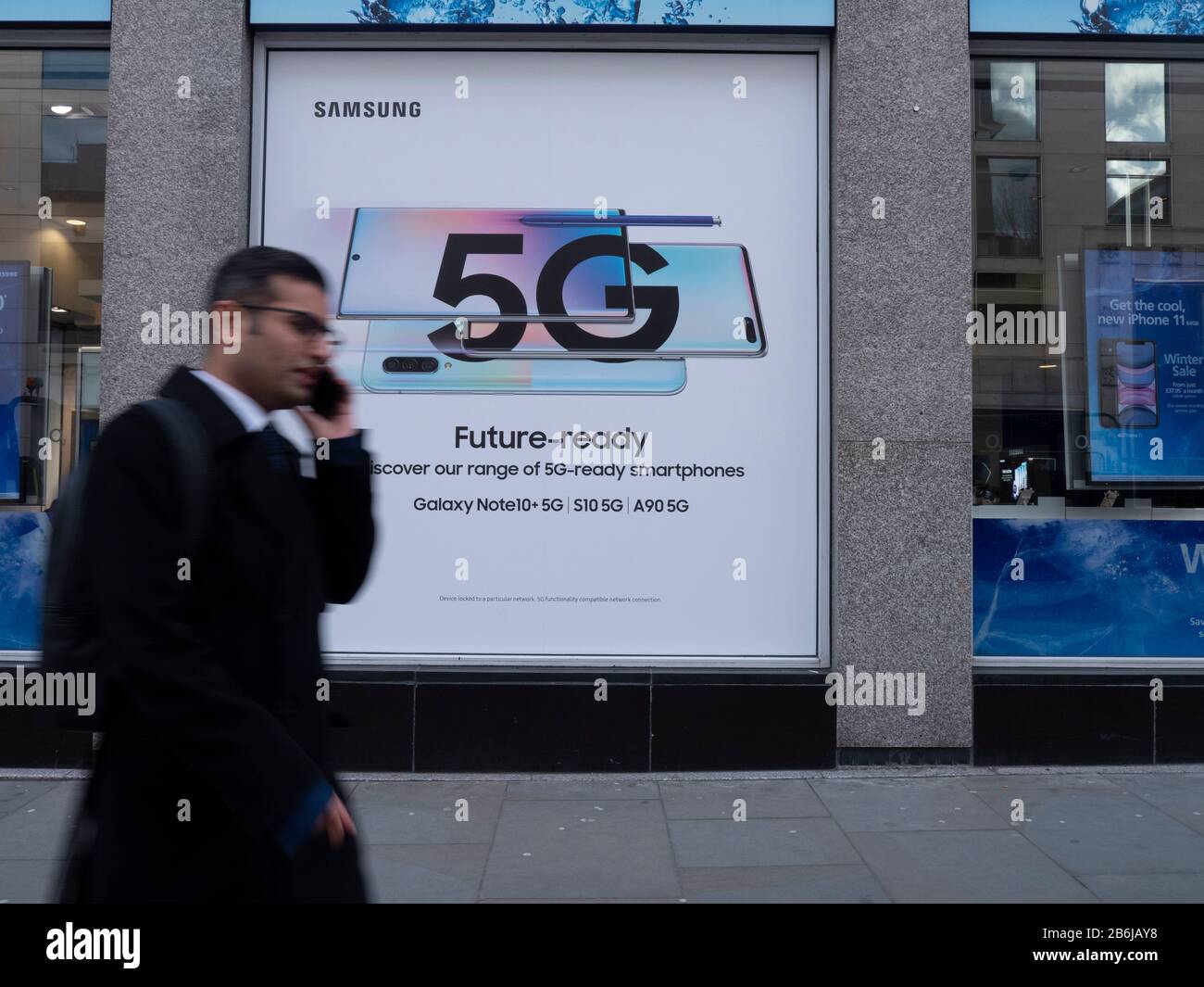 Réseau de 5 Go les téléphones samsung annoncés sur la boutique de l' à  Londres, avec un utilisateur de téléphone qui passe devant Photo Stock -  Alamy