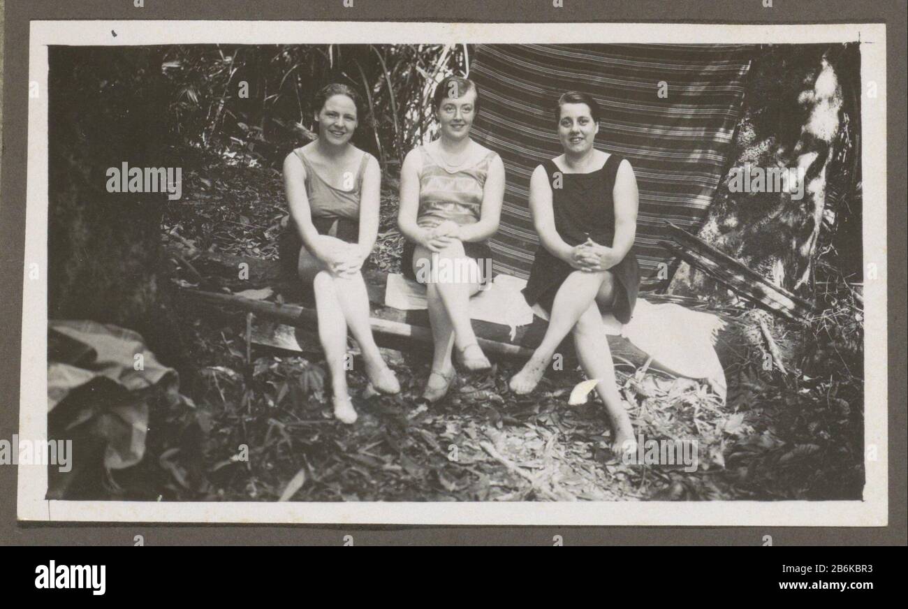 Trois femmes en maillots de bain assis sur un banc dans une forêt partie de l'album de famille néerlandais-Indië. Fabricant : Photographe: Anonyme Date: 1920 - 1930 Caractéristiques physiques: Gélatine argent imprimé matériel: Papier technique: Gélatine argent imprimé dimensions: H 65 mm × W 110 mm Sujet: Natation (sports) (+ équipement, tenue (sports, jeux, etc).) vêtements, costume (+ vêtements pour femmes) Où: Néerlandais East Indies Banque D'Images