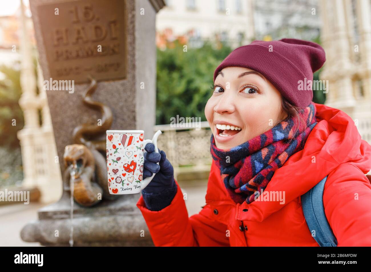 Une femme de tourisme boit de l'eau d'un ressort thermique médicinal à Karlovy Vary, en République tchèque Banque D'Images