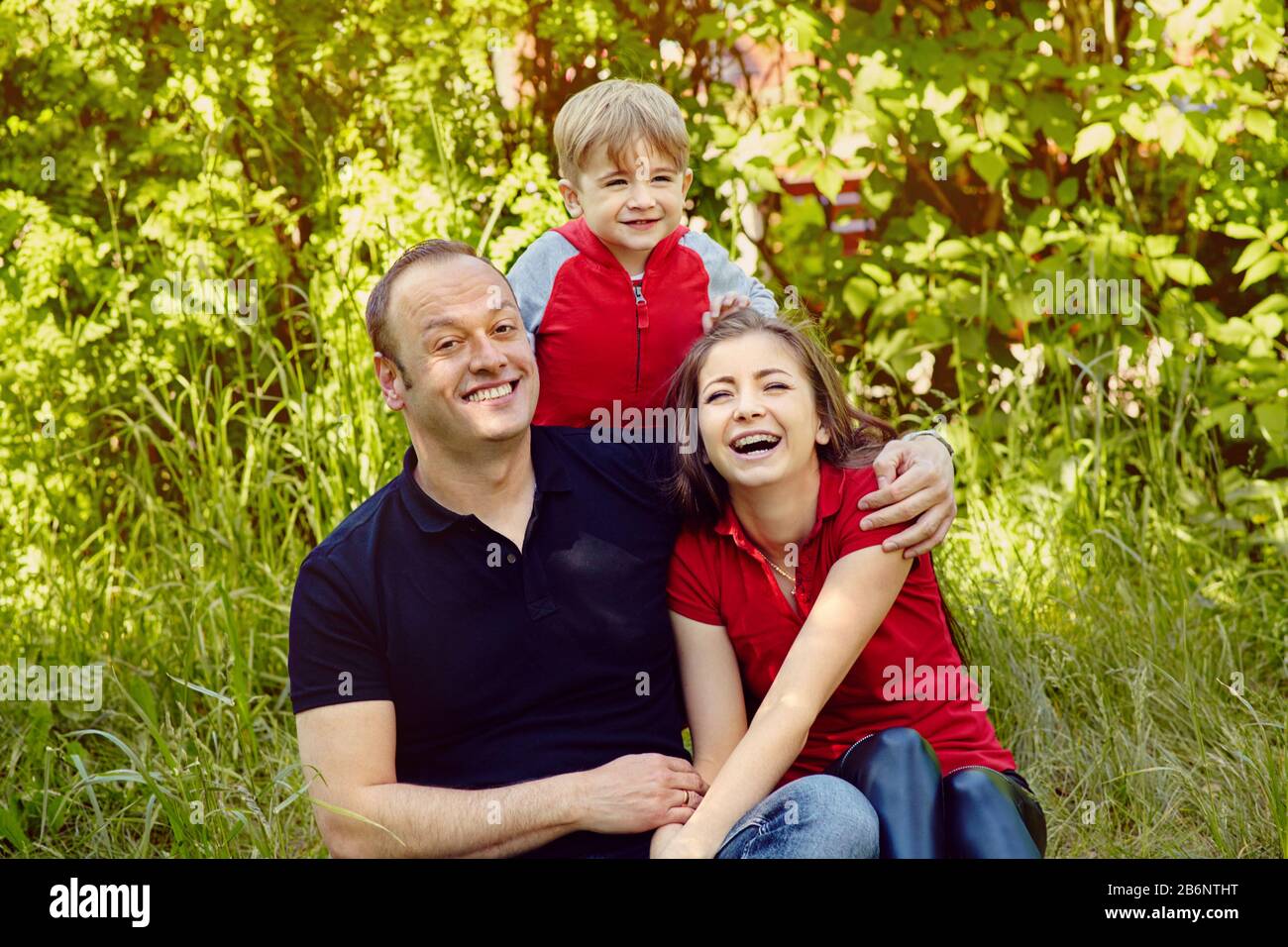 portrait extérieur d'une famille heureuse. Maman, papa et enfant. Banque D'Images