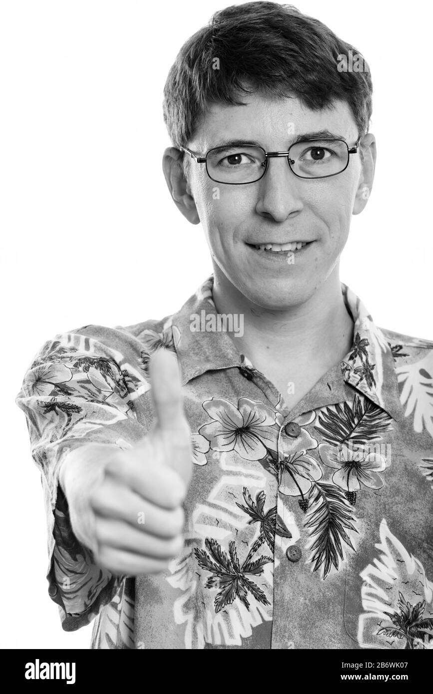 Studio shot of happy man smiling while giving thumb up Banque D'Images