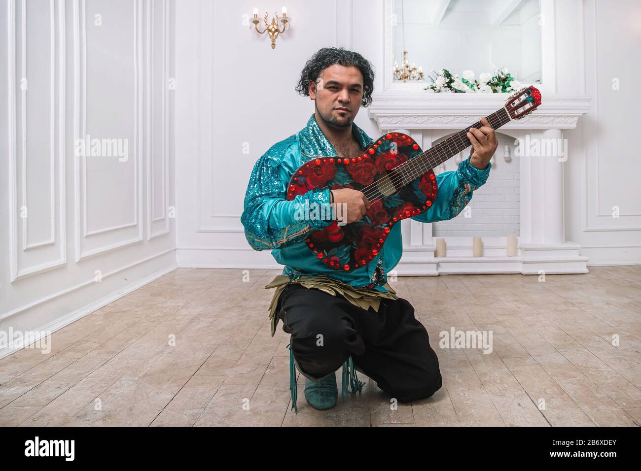 L'homme brutal Gypsy avec une guitare en chantant une chanson. Banque D'Images