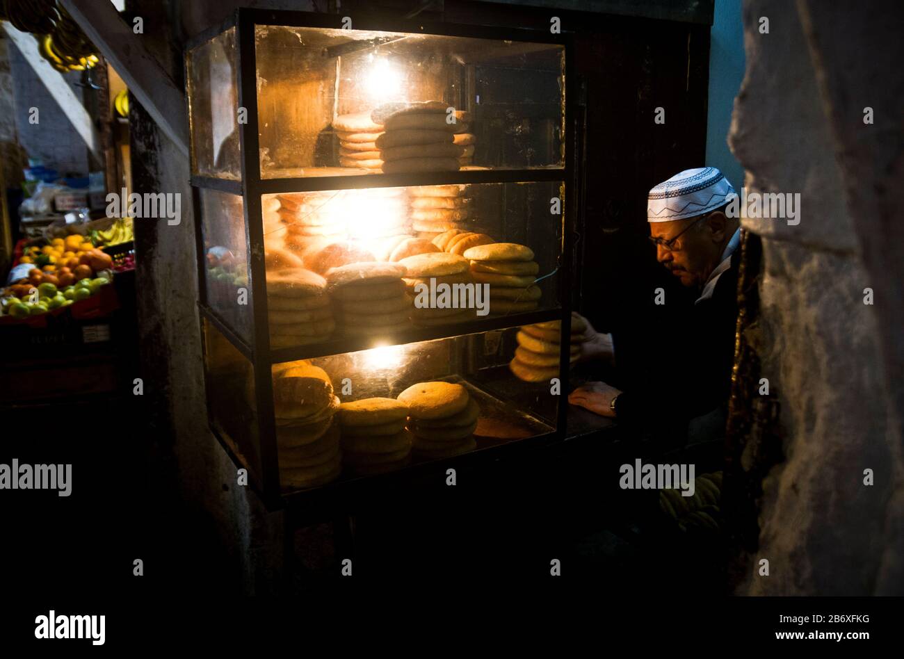 Un boulanger met du pain dans un présentoir à Fes, au Maroc Banque D'Images