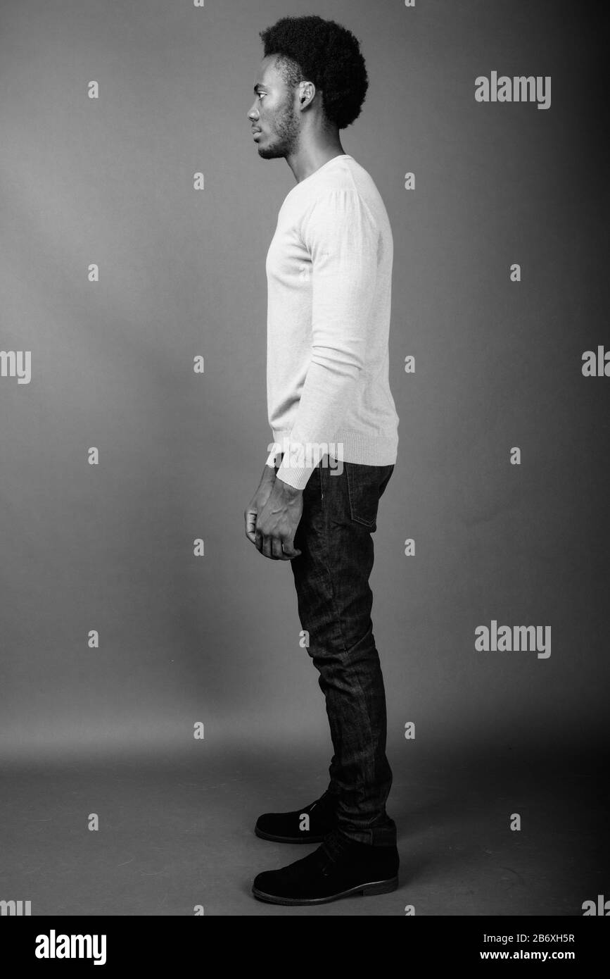 Beau jeune homme africain contre l'arrière-plan gris Banque D'Images