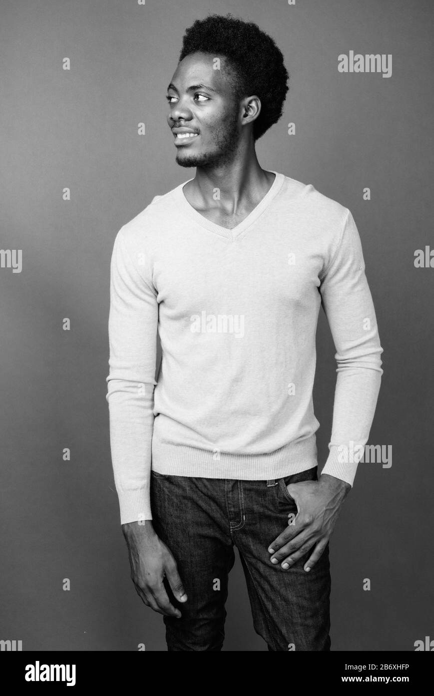 Beau jeune homme africain contre l'arrière-plan gris Banque D'Images