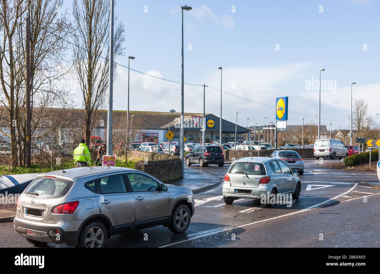 Carrigaline, Cork, Irlande. 12 mars 2020. Dans une heure de l’annonce par le gouvernement irlandais de nouvelles mesures pour lutter contre la propagation de l’épidémie de Covid-19 dans le pays, les files d’attente ont commencé à former des supermarchés extérieurs dans tout le pays. La photo montre les voitures qui attendent d'avoir accès au parking de Lidl à Carrigaline, Co. Cork, Irlande. - - - Crédit; David Creedon / Alay Live News Banque D'Images