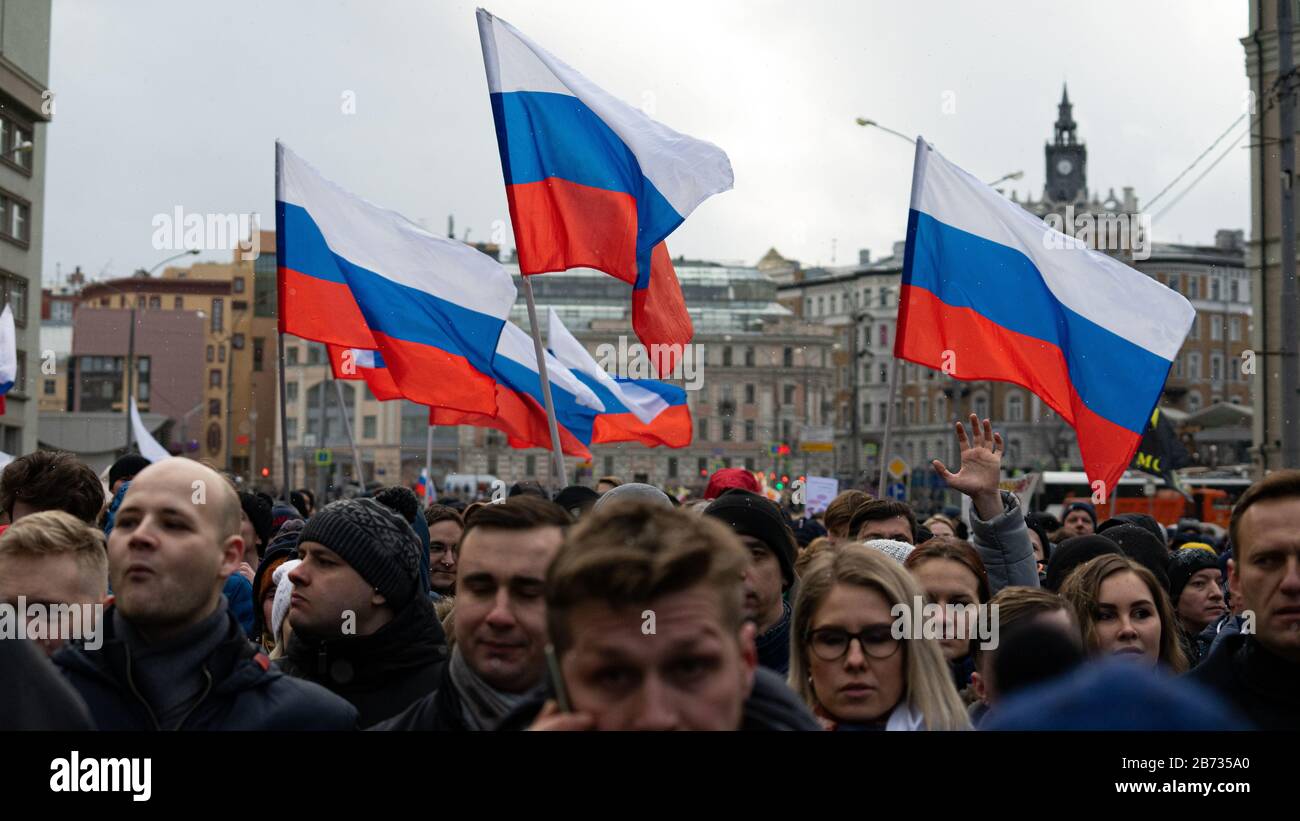 MOSCOU, RUSSIE - 29 FÉVRIER 2020, mars à la mémoire de Boris Nemtsov. Drapeaux de la Russie et du peuple, un homme dans la foule a soulevé sa main. Banque D'Images