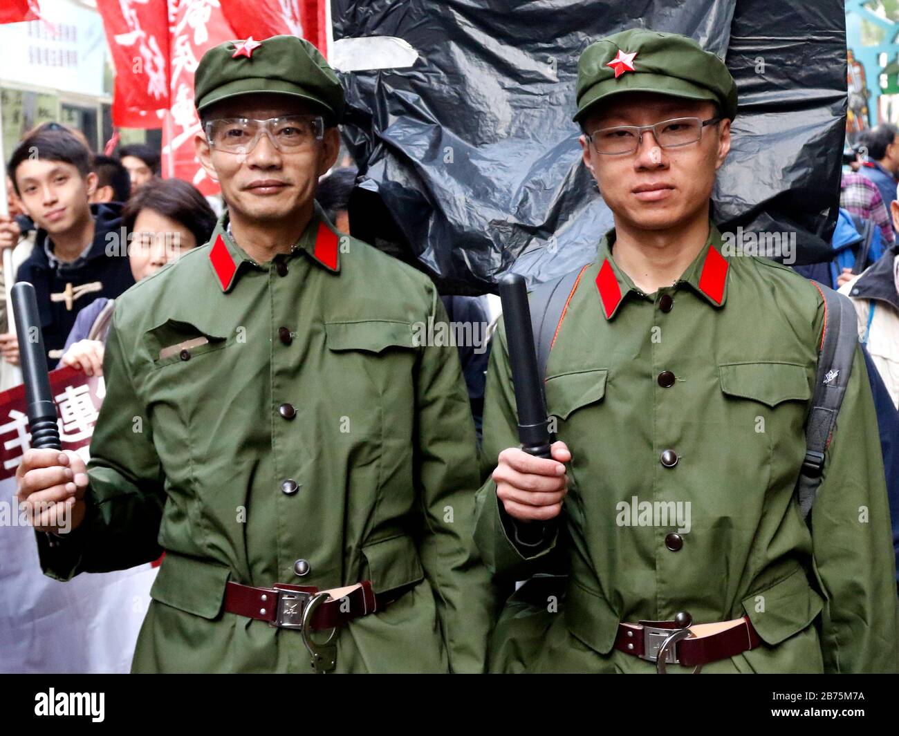 Deux hommes s'habillent dans le style d'un soldat chinois de l'époque de Mao le 1er janvier 2018 à Hong Kong. Une gare ferroviaire sera occupée par des agents chinois de l'immigration et des policiers après que les autorités chinoises auront statué qu'une partie d'une gare ferroviaire de la ville serait régie par la loi continentale. Banque D'Images