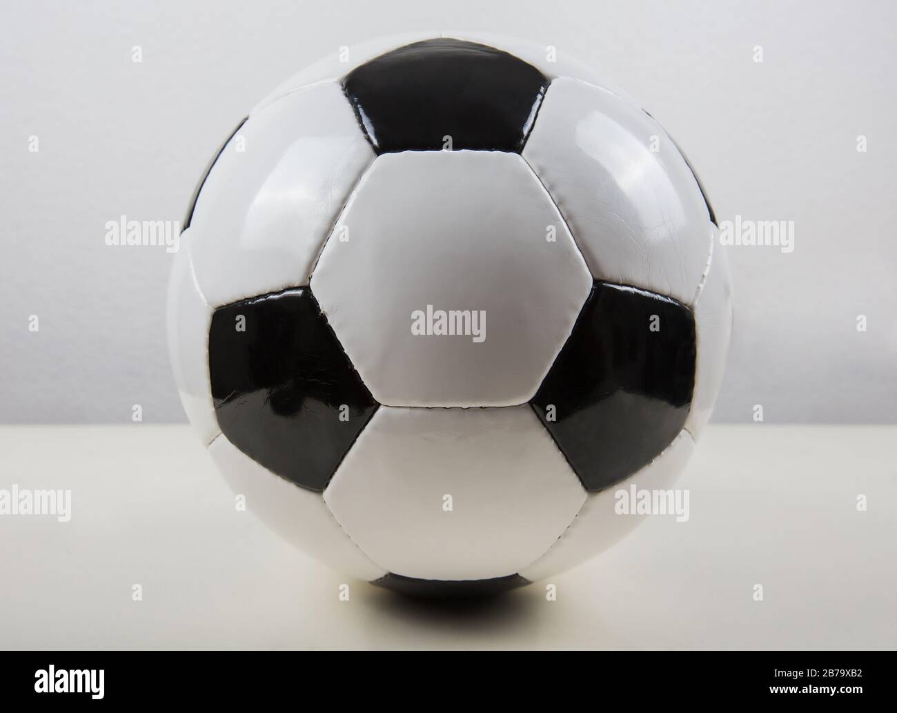 Ballon de football classique sur la table, motif noir et blanc, isolé sur  fond gris. Véritable symbole de ballon de football traditionnel Photo Stock  - Alamy