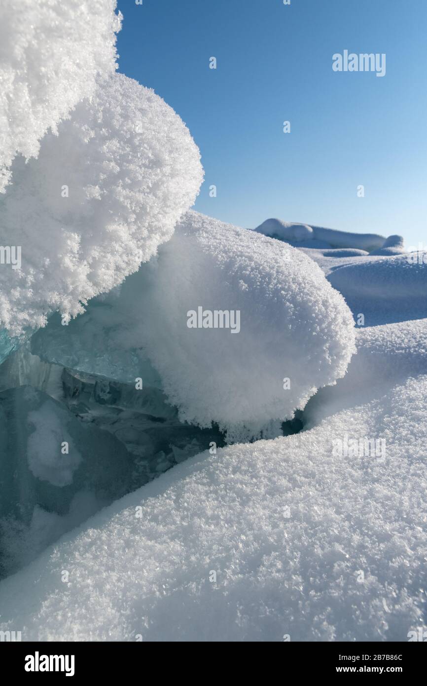 Floes de glace bleu transparent entassées dans des hummocks de glace contre un ciel bleu par temps ensoleillé. Paysage hivernal inhabituel du lac gelé Baikal. Froid naturel b Banque D'Images Floes de glace bleu transparent entassées dans des hummocks de glace contre un ciel bleu par temps ensoleillé. Paysage hivernal inhabituel du lac gelé Baikal. Froid naturel b Banque D'Images
