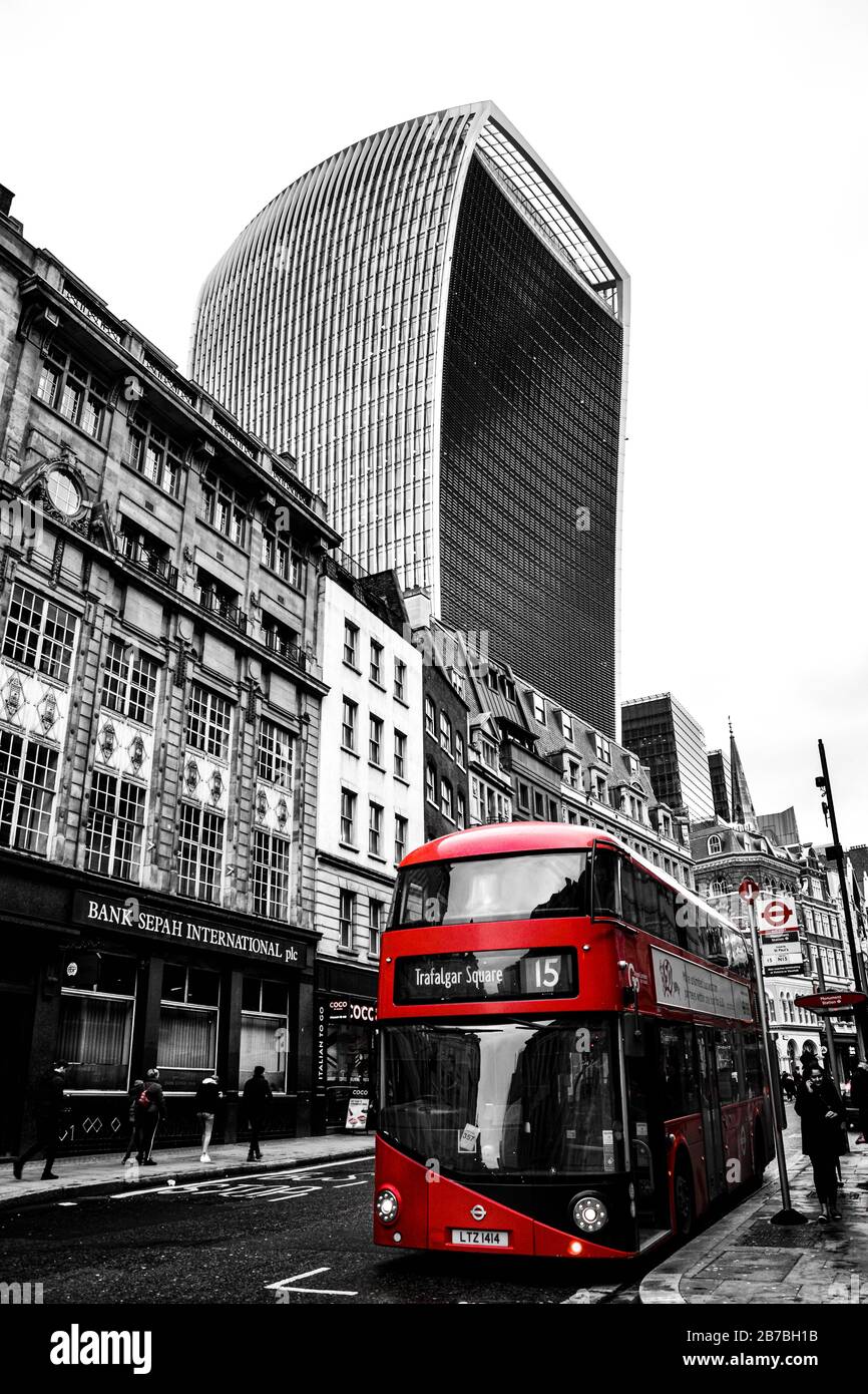 LONDRES, ANGLETERRE - 24 décembre 2019: Une photo en noir et blanc d'un immeuble Walkie Talkie avec un bus rouge en face Banque D'Images