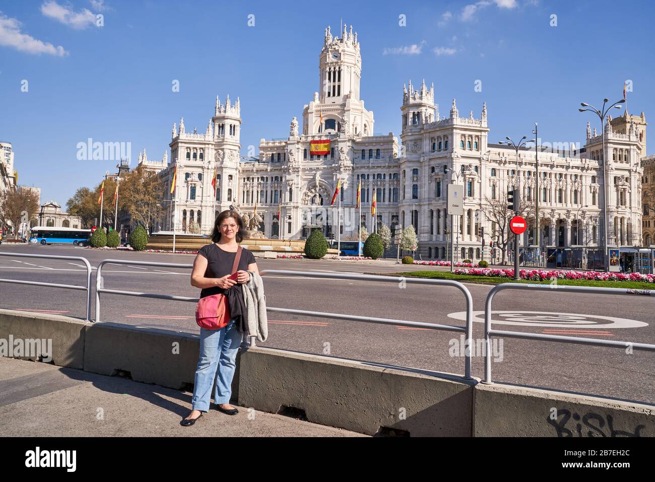 Une dame pose par le Palais des bureaux de poste de communication et de l'hôtel de ville avec la fontaine de Cibeles un monument dans le centre de Madrid, Espagne Banque D'Images Une dame pose par le Palais des bureaux de poste de communication et de l'hôtel de ville avec la fontaine de Cibeles un monument dans le centre de Madrid, Espagne Banque D'Images