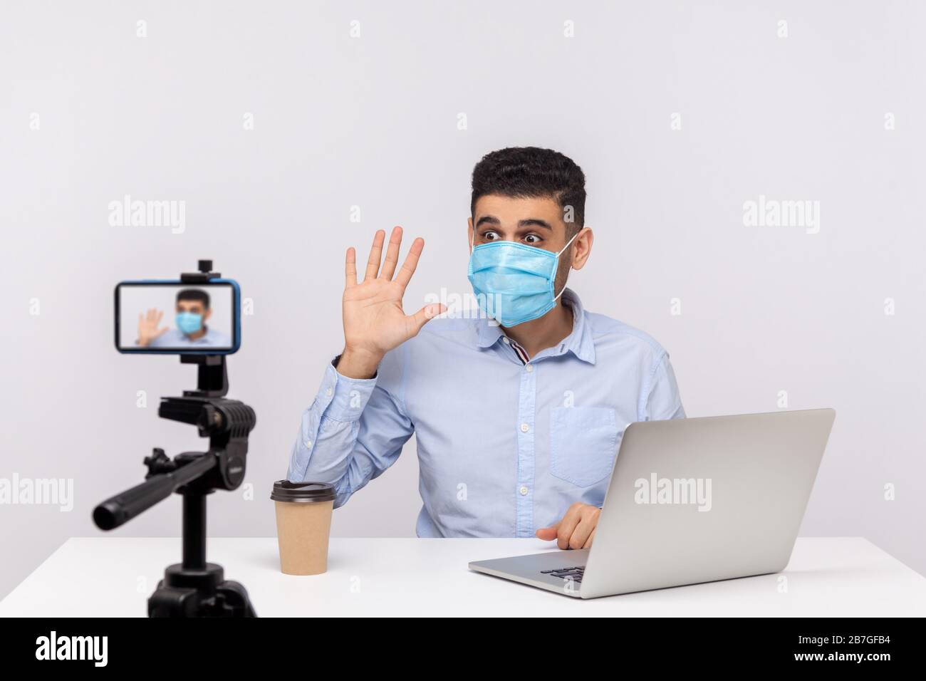 Blogger masculin dans le masque médical de la vidéo, en ligne de streaming sur les nouvelles de coronavirus, donnant des conseils sur l'utilisation de protéger le filtre contre la maladie contagieuse. Dans Banque D'Images