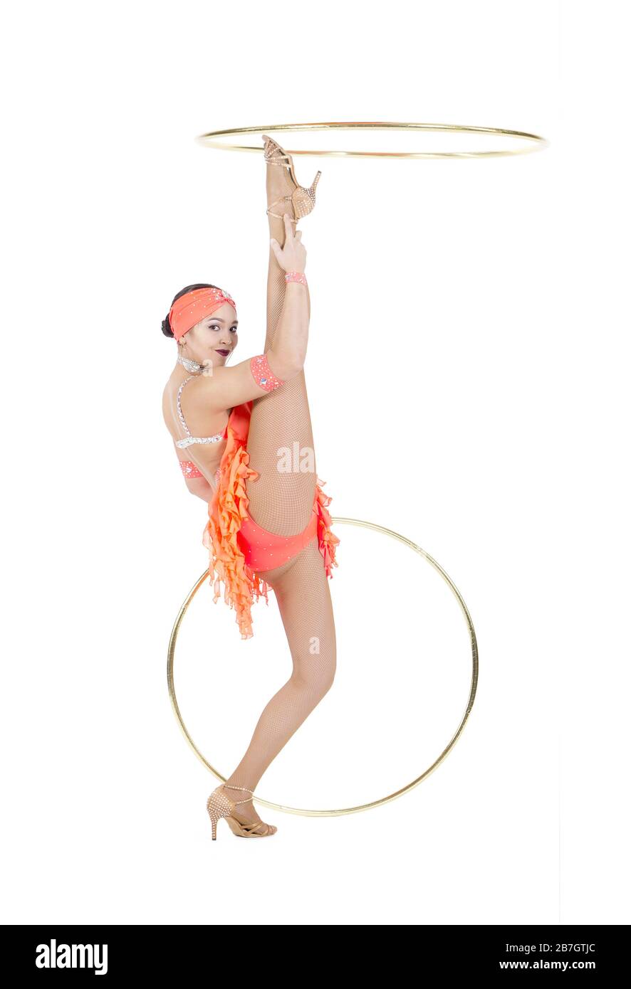 Une femme dans une robe de scène exécute une danse avec un hula Hoop. Prise de vue en studio sur fond blanc. Banque D'Images