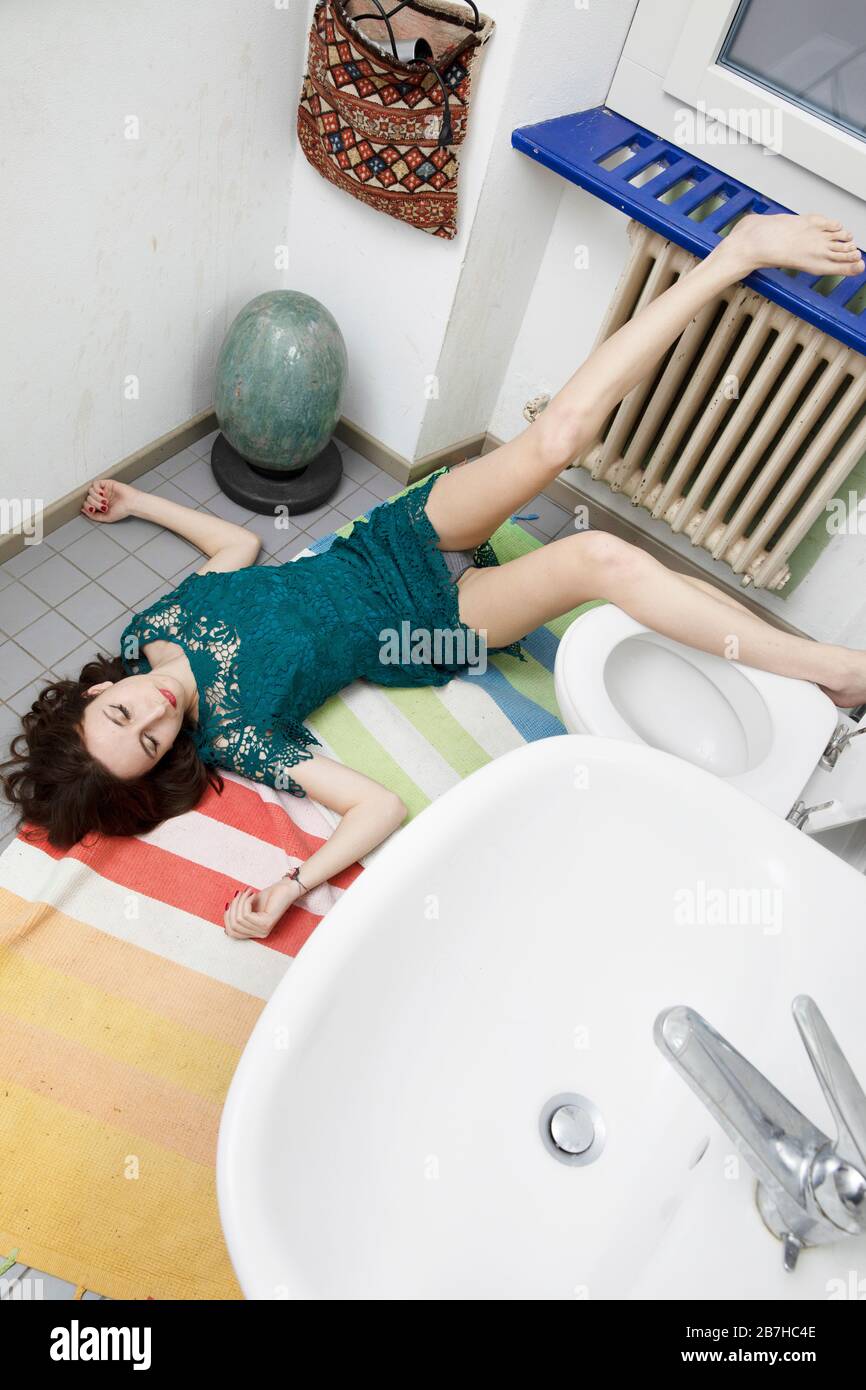 Jeune femme allongé dans la salle de bains après une mauvaise chute,  situation typique d'accident domestique Photo Stock - Alamy