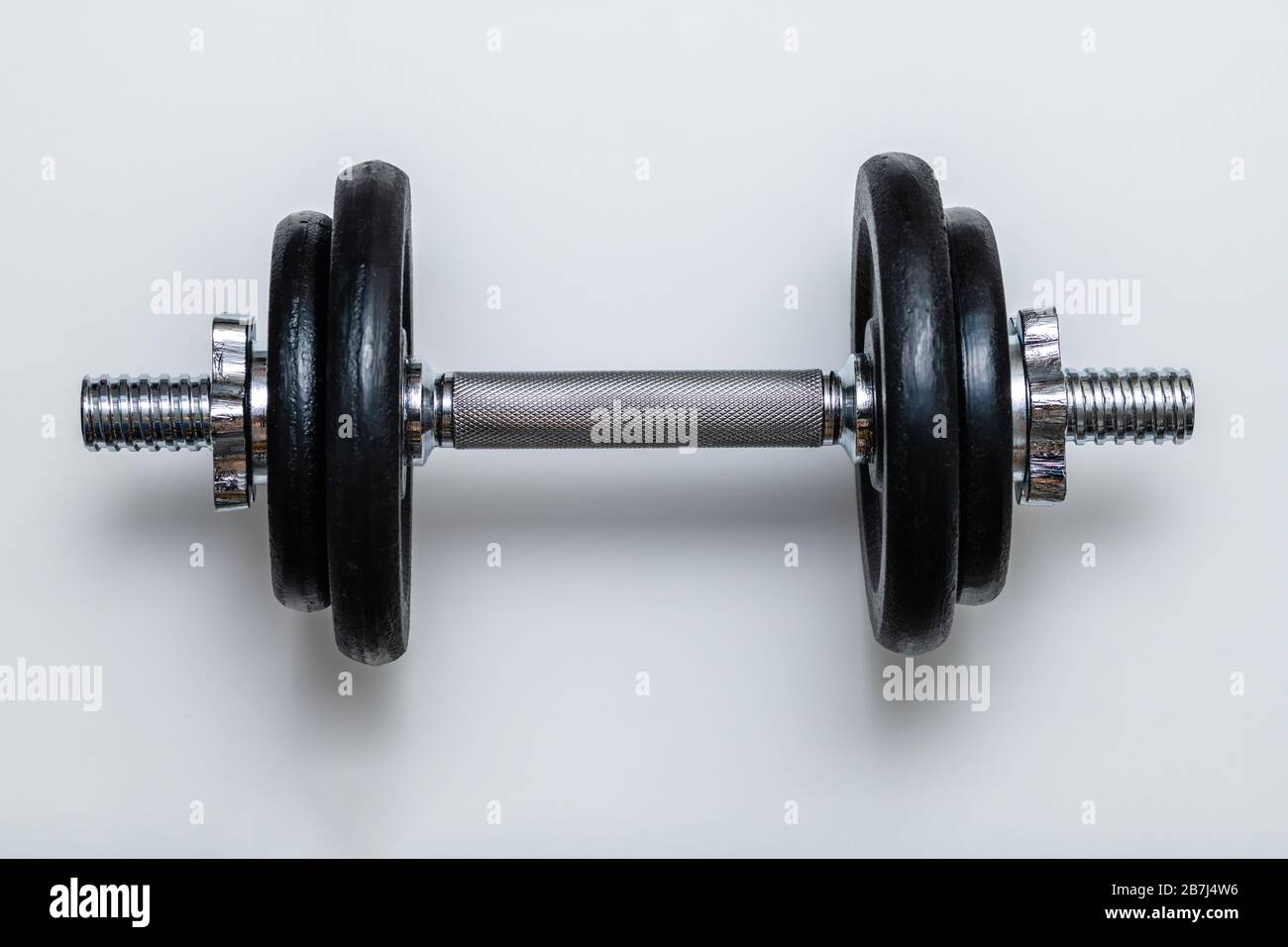 Haltères réglables isolés avec poids noirs et poignée chromée sur fond blanc. Concept d'entraînement, de forme physique et d'exercice pour une vie saine Banque D'Images