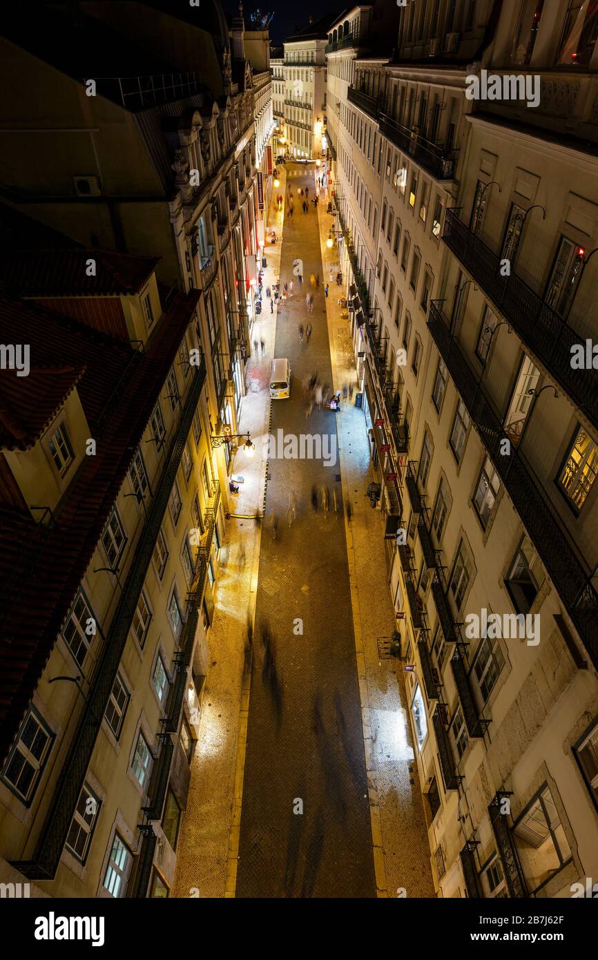 Vue sur les bâtiments éclairés et sur la rue Rua do Carmo dans le quartier Baixa de Lisbonne, Portugal, d'en haut la nuit. Banque D'Images