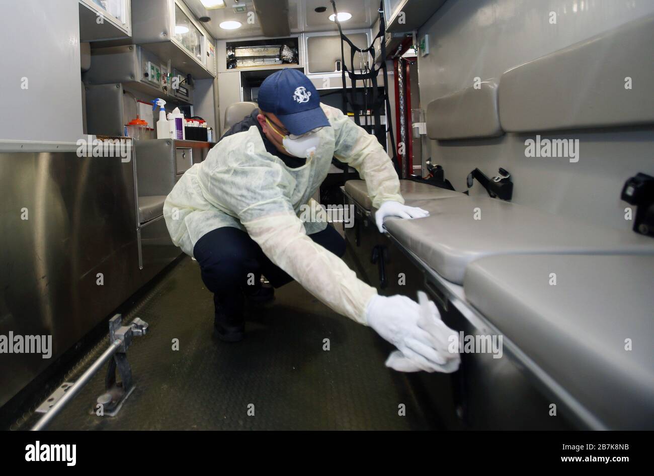 St. Louis, États-Unis. 16 mars 2020. Le paramédic du Service d'incendie de St. Louis Andrew Beasley porte un masque, des gants et une robe lorsqu'il désinfecte le dos d'une ambulance avec un mélange d'eau de Javel, après avoir remis un patient au Service d'urgence de l'hôpital Barnes-Juive à Saint-Louis le lundi 16 mars 2020. Les équipages prennent des précautions spéciales pour se protéger contre le Coronavirus. La ville de Saint-Louis a enregistré son premier cas de virus. Photo de Bill Greenblatt/UPI crédit: UPI/Alay Live News Banque D'Images