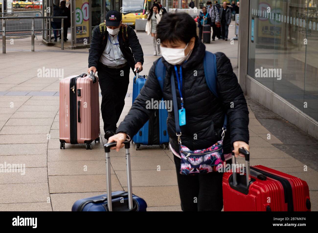 Les passagers portant des masques de protection se rendent à la gare de Piccadilly à Manchester, le lendemain que le Premier ministre Boris Johnson a appelé les gens à rester à l'écart des pubs, clubs et théâtres, travailler à domicile si possible et éviter tous les contacts et les déplacements non essentiels afin de réduire l'impact de la pandémie de coronavirus. Banque D'Images