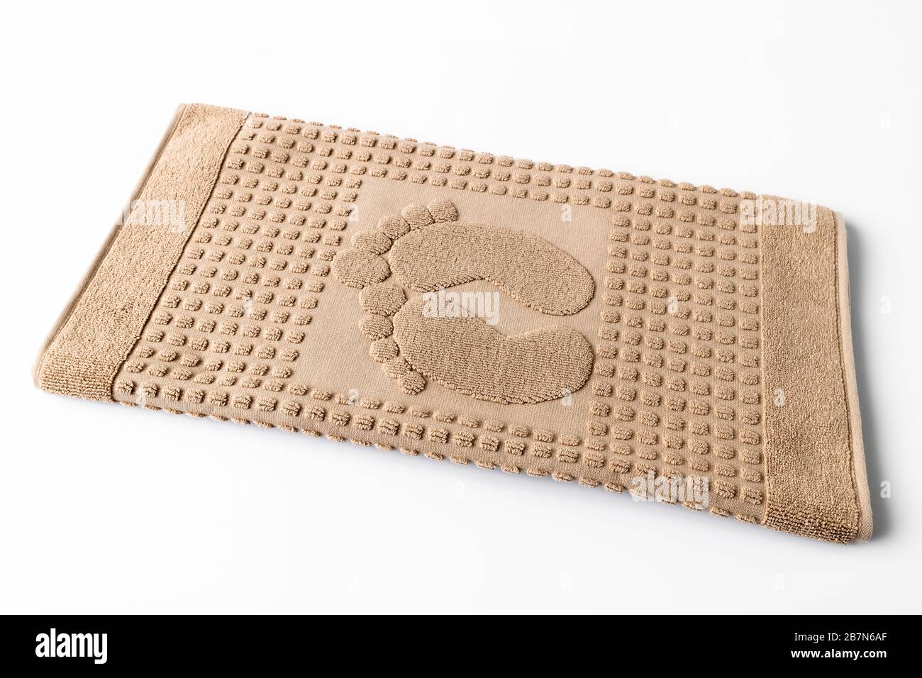 Serviette de bain beige pour jambes sur fond clair Banque D'Images