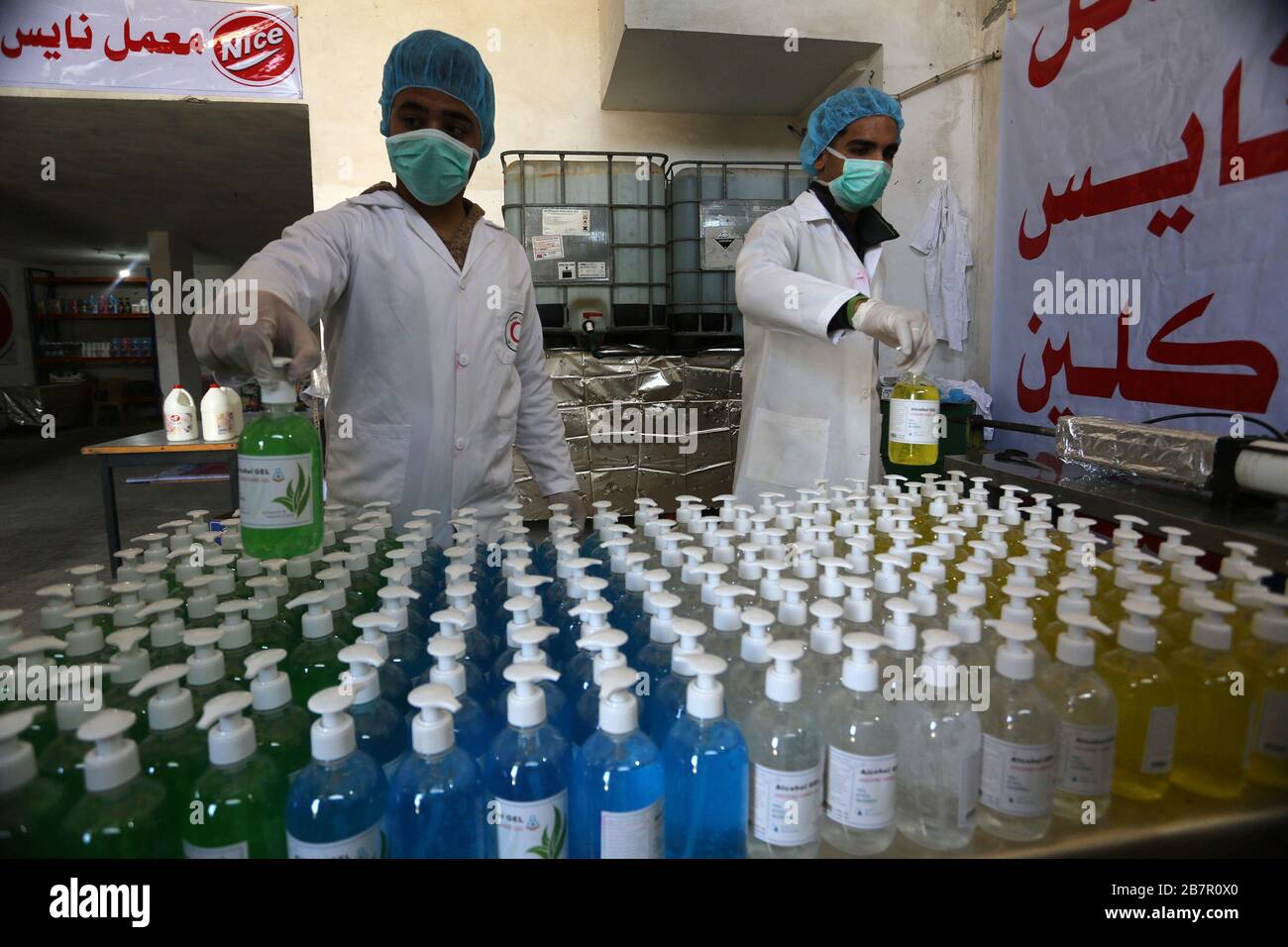 Le 16 mars 2020, les travailleurs palestiniens qui font du gel désinfectant pour les mains dans une usine de Khan Younis, dans le sud de la bande de Gaza. Photo d'Abed Rahim Khatib Banque D'Images