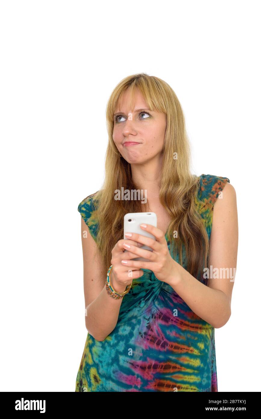 Portrait de belle blonde woman thinking lors de l'utilisation de Phone Banque D'Images