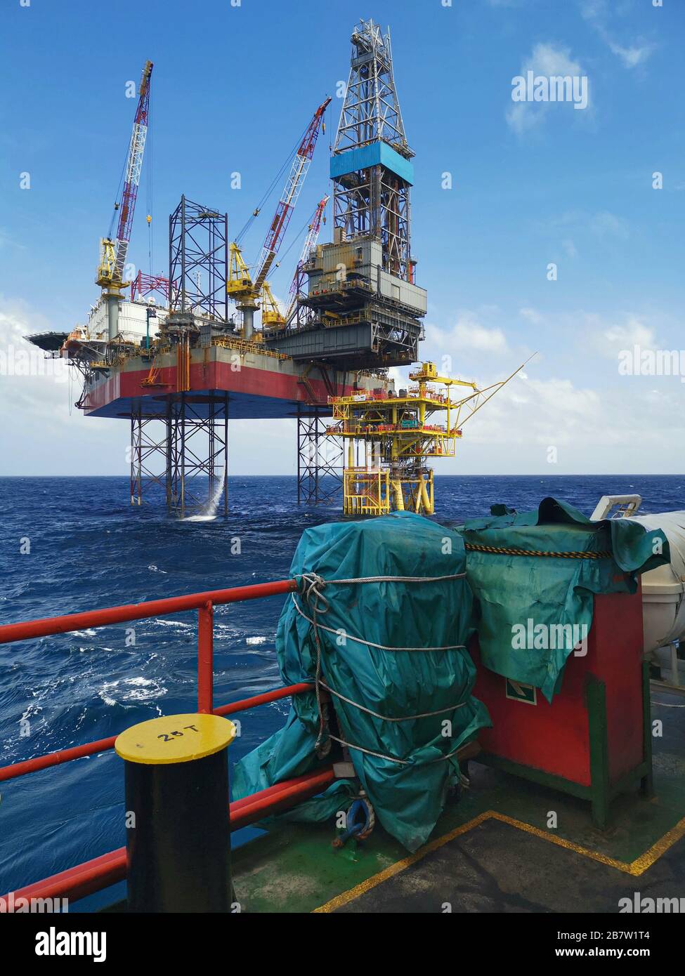 engin de levage à cric et forage de plate-forme pétrolière en mer avec un robot de sauvetage et une grue du navire Banque D'Images
