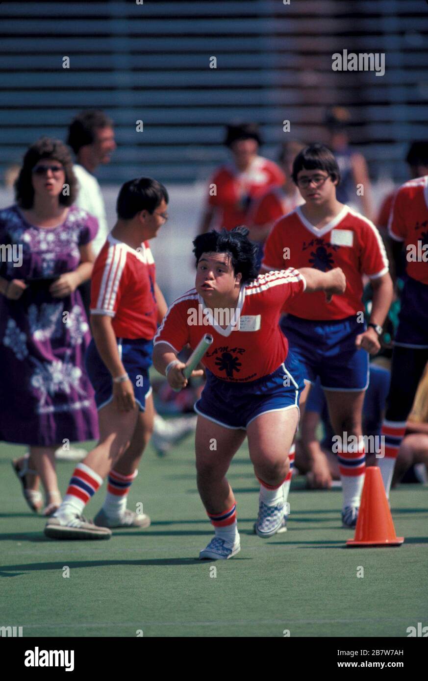 Austin Texas USA: Un compétiteur ado tenant le bâton commence sa jambe d'une course de relais lors d'une rencontre spéciale de piste des Jeux Olympiques pour les enfants intellectuellement handicapés. ©Bob Daemmrich Banque D'Images