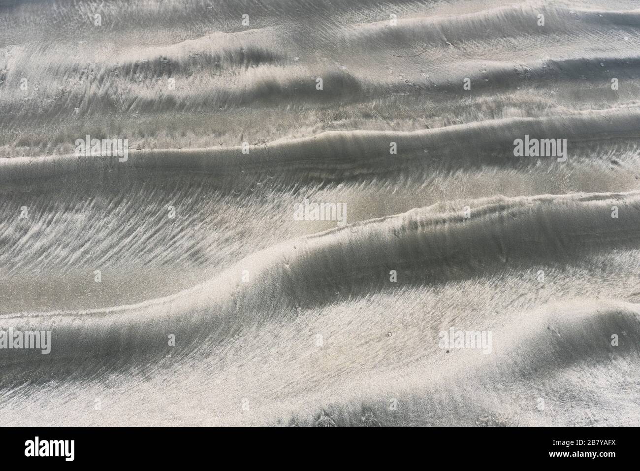 dh MOTIF SABLE Sandy texture de la mer ondulée Banque D'Images