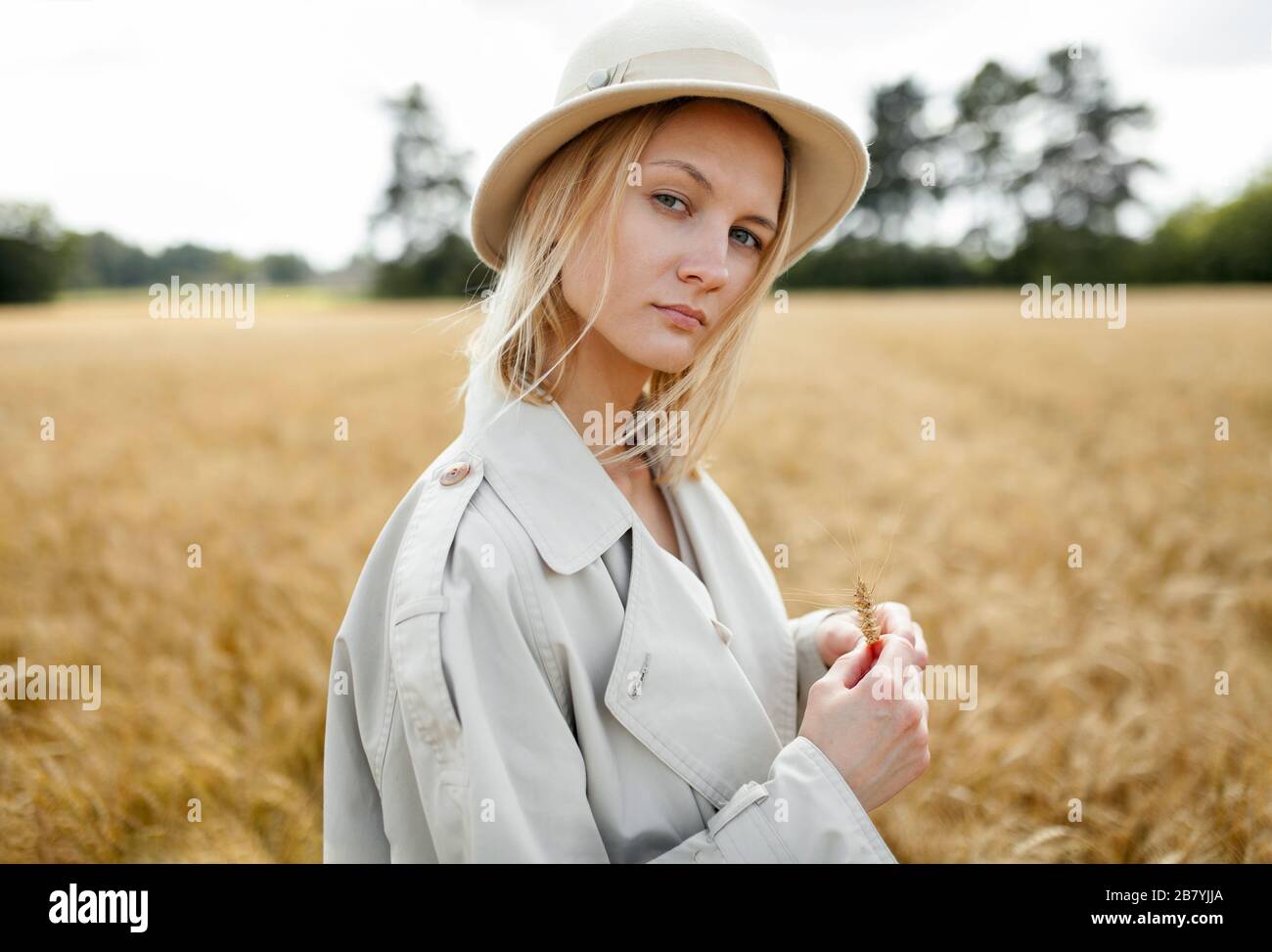 Jeune femme avec fedora dans le champ de blé Banque D'Images