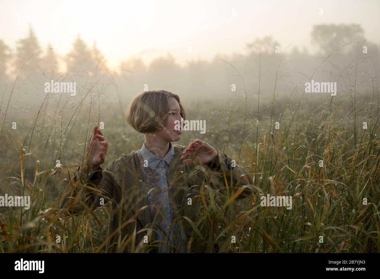 Jeune femme dans le champ de l'herbe longue Banque D'Images