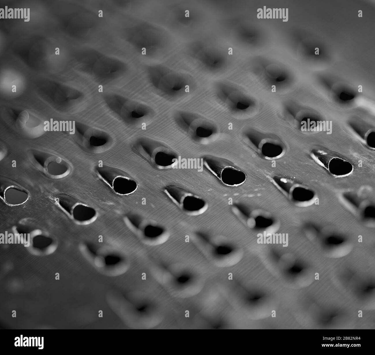 Macro photographie d'un râpe à fromage. Banque D'Images