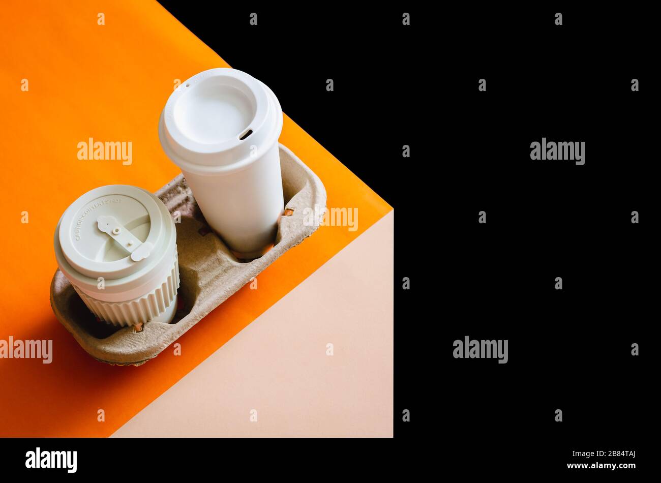 Les tasses de café de recyclage dans le bac à papier de réutilisation mis sur papier coloré et fond sombre pour le concept d'environnement mondial. Banque D'Images