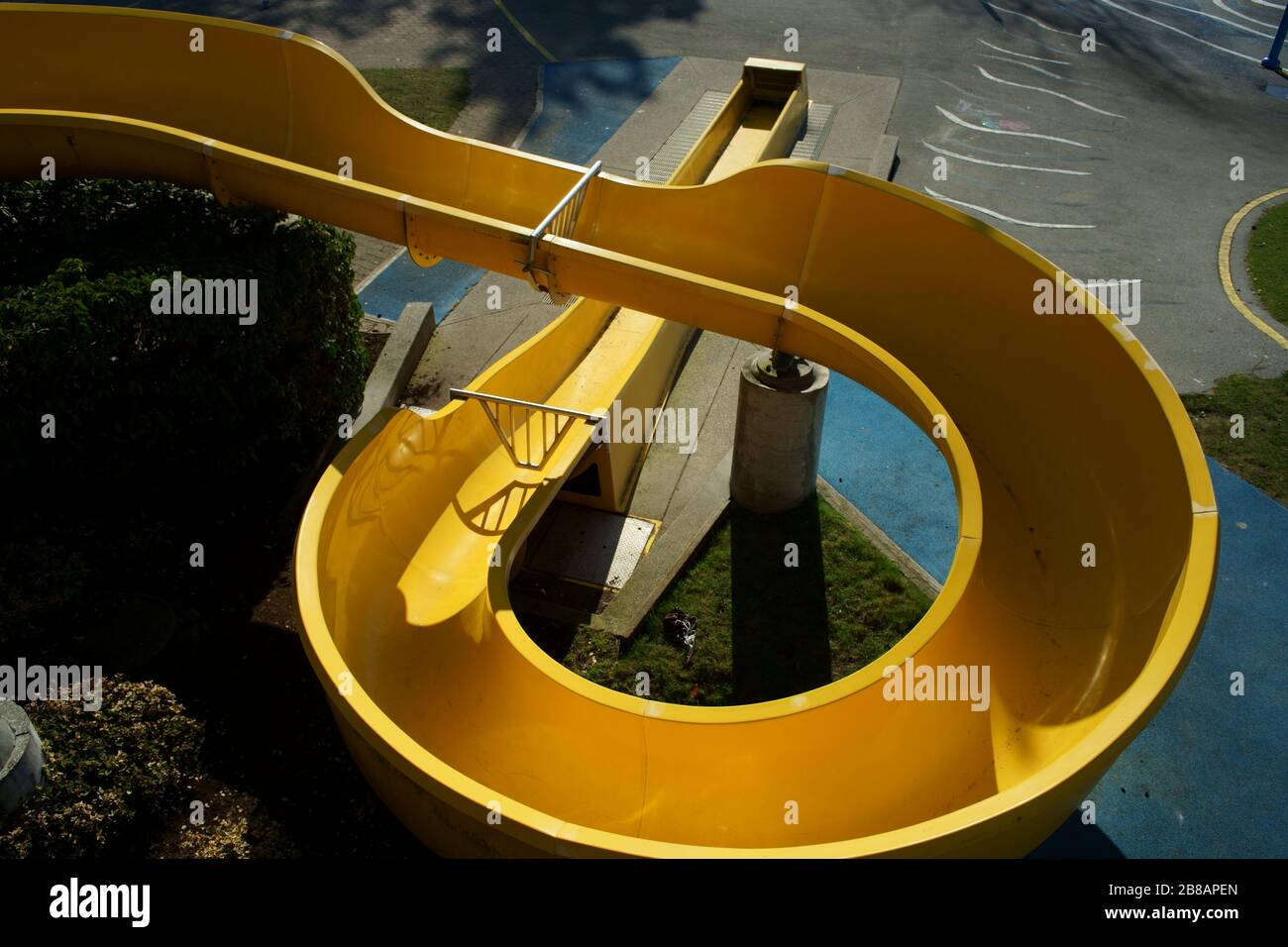 Photo d'un toboggan en spirale jaune dans un parc pour enfants pendant l'éclosion de coronavirus Banque D'Images