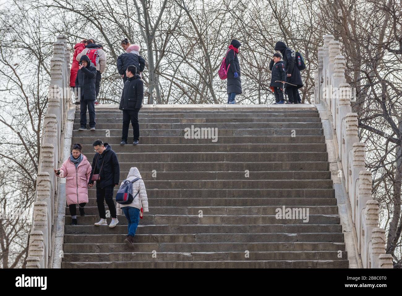 Touristes sur le pont de la ceinture de Jade sur un lac Kunming au Palais d'été, ancien jardin impérial à Beijing, Chine Banque D'Images
