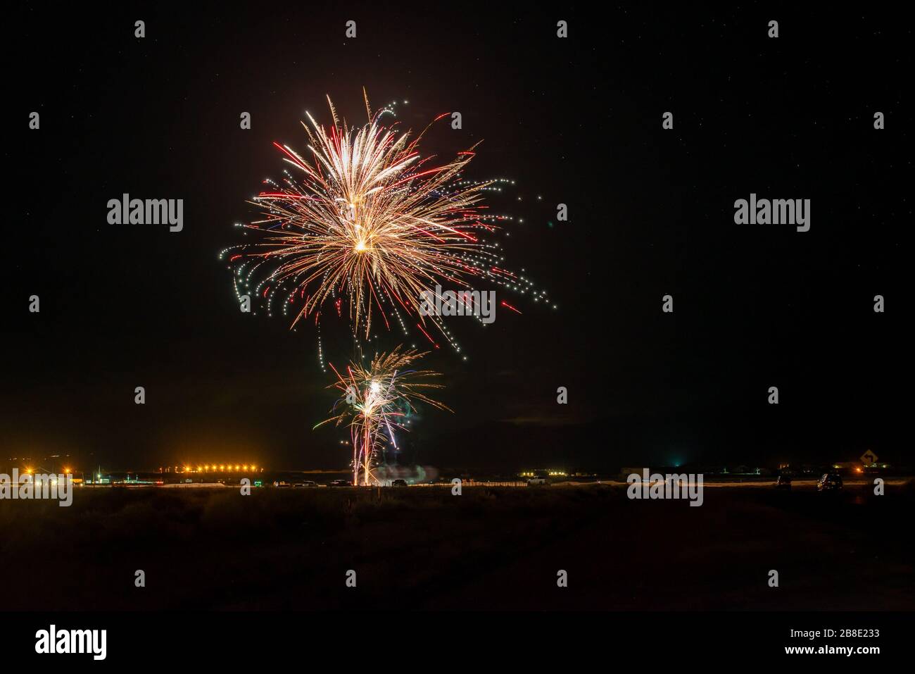 États-Unis, Nevada, Comté d'Esmerelda, Hawthorne. Une explosion de feux d'artifice rouges sous un ciel étoilé dans le désert. Banque D'Images