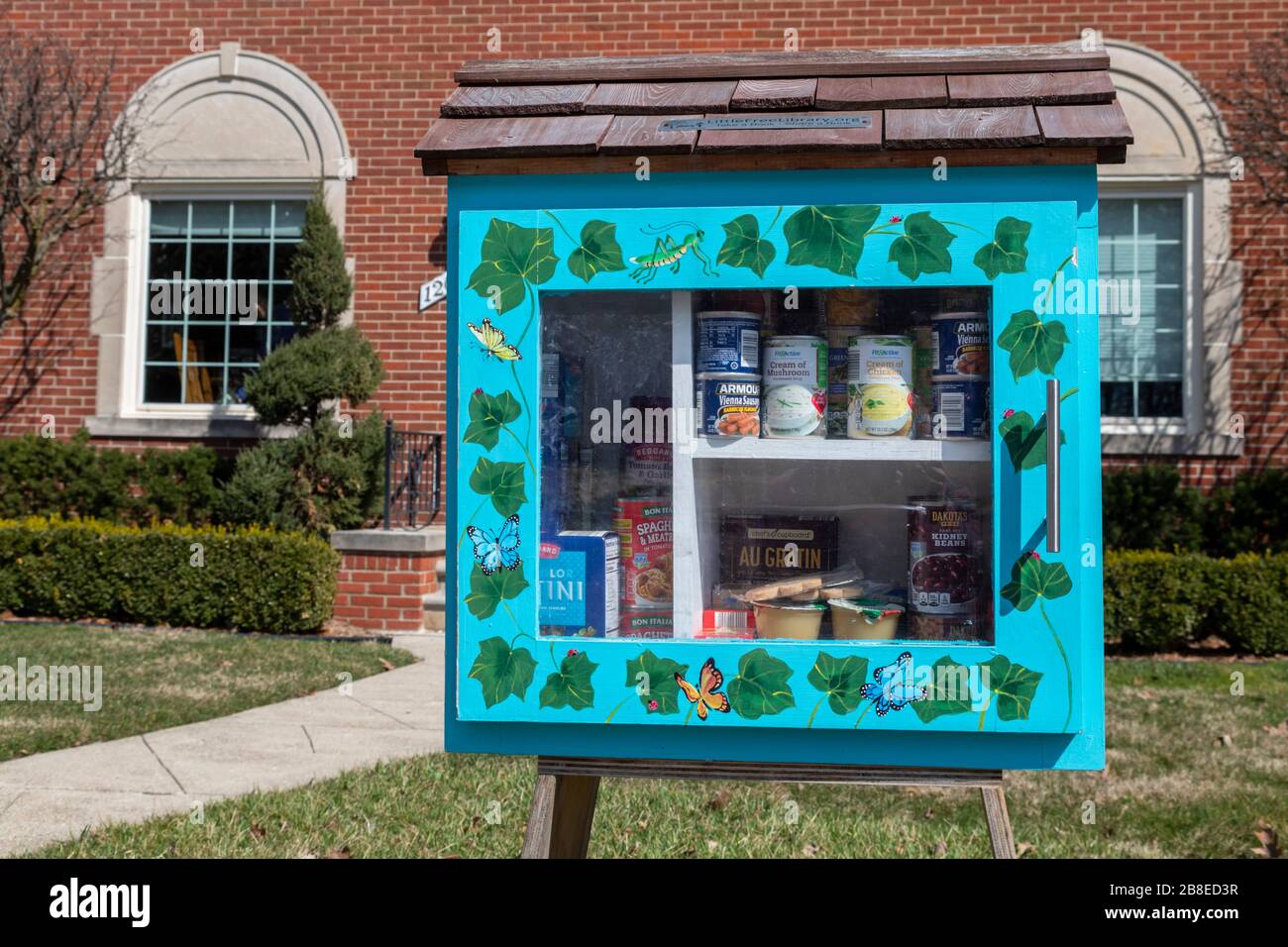 Detroit, Michigan, États-Unis. 21 mars 2020. Une petite bibliothèque libre, convertie en échange/distribution de nourriture libre en raison de la crise du coronavirus. La bibliothèque a été placée devant leur domicile par deux ministres, le pasteur Vicki Hesse et le pasteur Leah McCullough. Crédit: Jim West/Alay Live News Banque D'Images