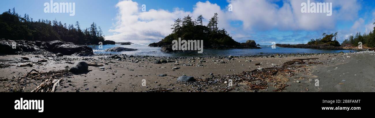 Panorama de la plage vide de la côte ouest du Canada avec des îles rocheuses, des vagues, du sable et des arbres Banque D'Images