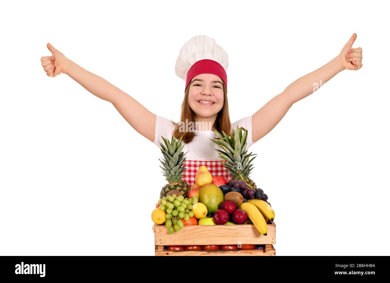 bonne cuisinière féminine avec fruits et pouces vers le haut Banque D'Images