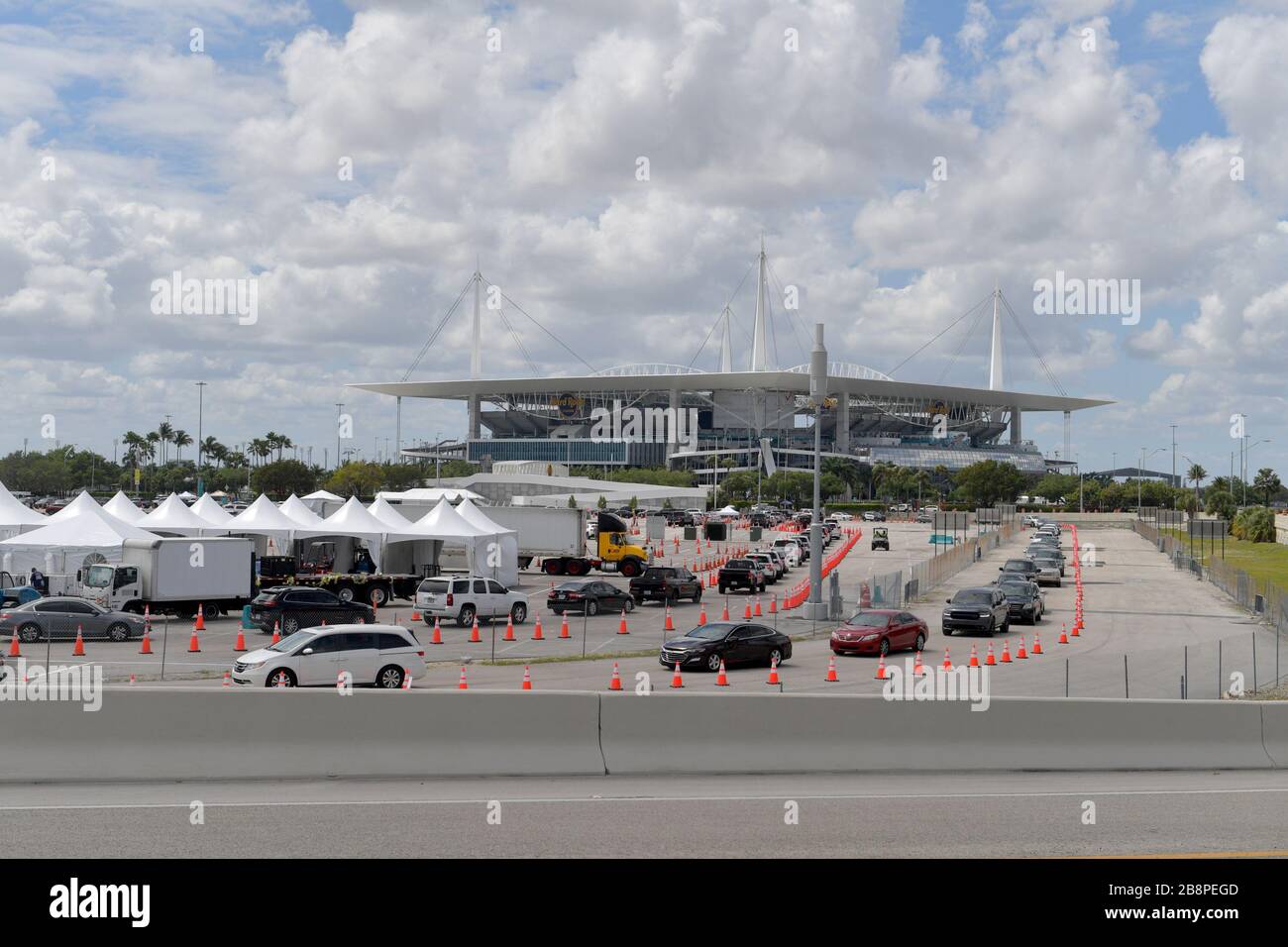 Miami Gardens, Floride, États-Unis. 23 mars 2020. Au lieu de se mettre en place pour le tournoi de tennis de Miami Open, la Garde nationale de Floride (beaucoup sans masques de visage en raison d'une pénurie) J'ai été en train de faire un essai en voiture au large de l'autoroute Florida Turnpike au Hard Rock Stadium de Miami Gardens, où les gens peuvent passer un test COVID-19 sans sortir de leur voiture. Comme le nombre de cas de COVID-19 de Miami-Dade CountyÕs atteint 169, le site sera ouvert lundi à 9 heures dans le parking est du Hard Rock Stadium, 347 Don Shula Drive. Crédit: Groupe médias de tempêtes/Alay Live News Banque D'Images