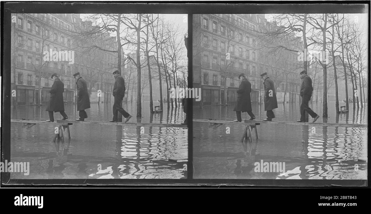Cue de la Seine trois personnes traversant l'avenue Ledru Rollin sur un pont de planche (11ème / 12ème arrondissement). Paris. 'Cue de la Seine : trois personnes traversant l'avenue Ledru Rollin sur une passerelle de planches, Paris (XI et XIIème arr.)'. Photo de Lucien Cresson. Vue stérique : négatif sur plaque de verre au gélatino-bromure d'argent. 1910. Paris, musée Carnavalet. Banque D'Images