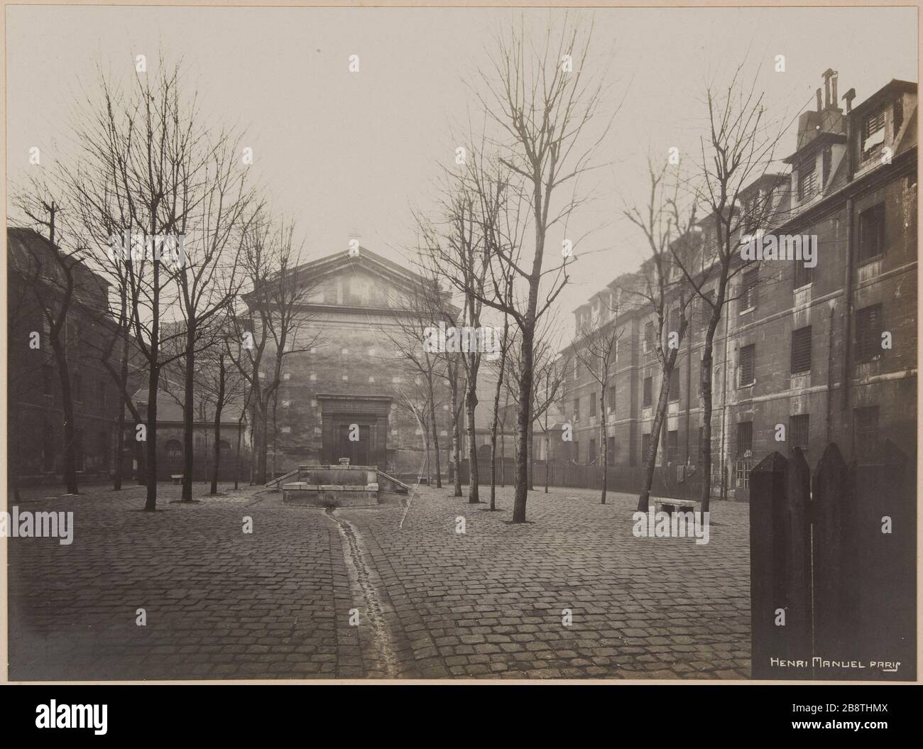 aire d'entraînement avec la chapelle et la buanderie où les prisonniers ont dû faire la lessive. Prison Saint-Lazare, prison pour femmes, 107 rue du Faubourg Saint-Denis, 10ème arrondissement, Paris. Cour de promenade avec la chapelle et le lavoir où les prisonniers devaient faire la cessive. Prison Saint-Lazare, maison d'arrêt pour femmes, 107 rue du Faubourg-Saint-Denis. Paris (Xème arr.). Photographie d'Henri Manuel (1874-1947). Rage gélatino-argentique au bromure sur papier. Image assemblée sur une page d'album cartonnée. Agrandisation d’après une plaque négative sur verre. 1929-1931. Paris, musée Carnavalet. Banque D'Images