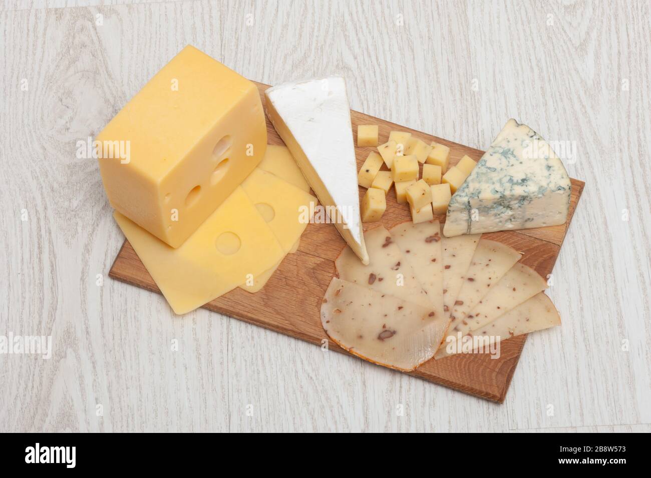 Différents types de fromage Roquefort, fromage à la noix, brie, sur une planche en bois. Banque D'Images