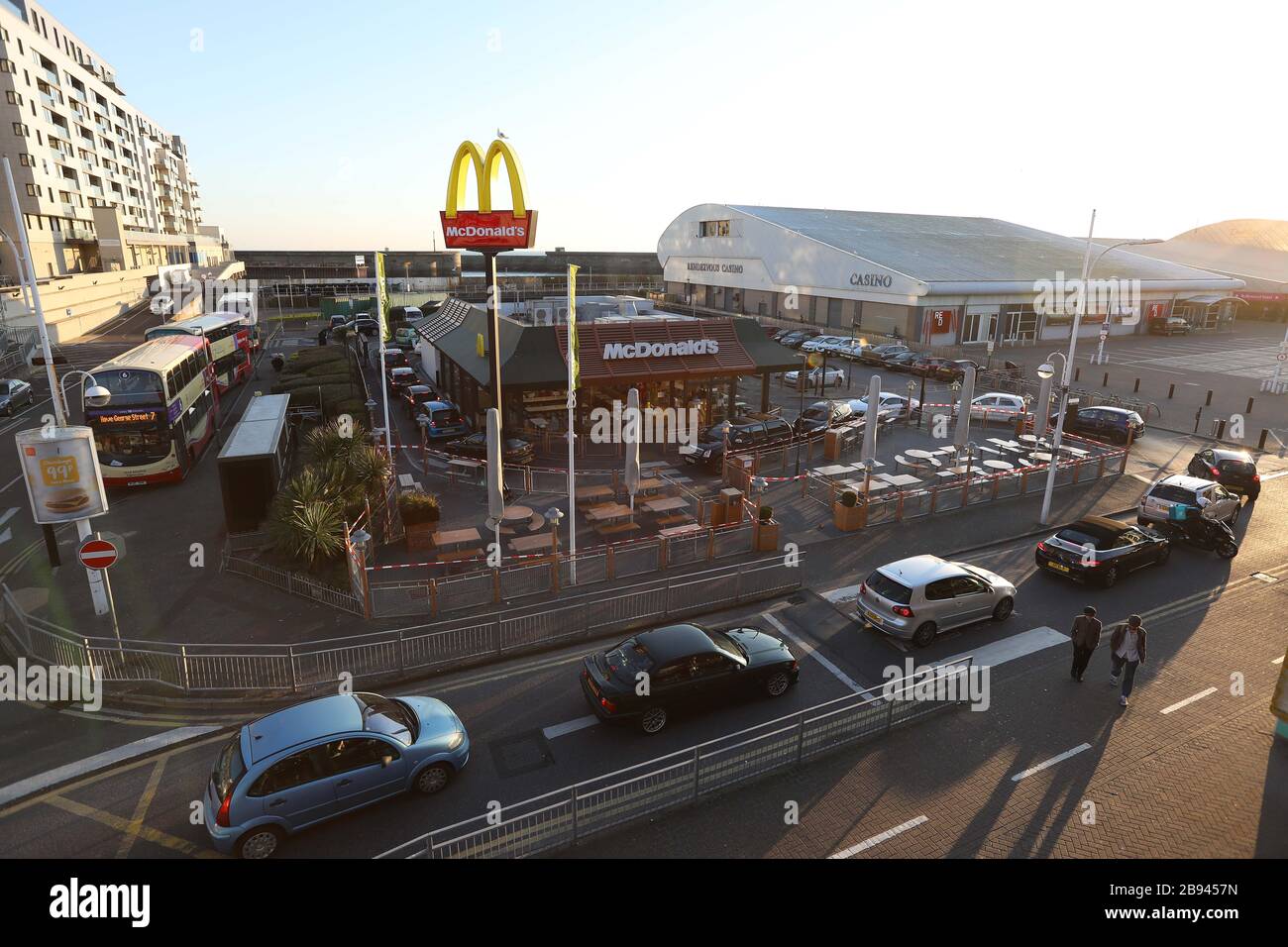 Brighton, Royaume-Uni. 23 mars 2020. Les clients du McDonalds qui font la queue dans leurs voitures peu avant que le restaurant Fast-food ne ferme ses portes en raison de l'épidémie de Coronavirus. Crédit: James Boardman/Alay Live News Banque D'Images