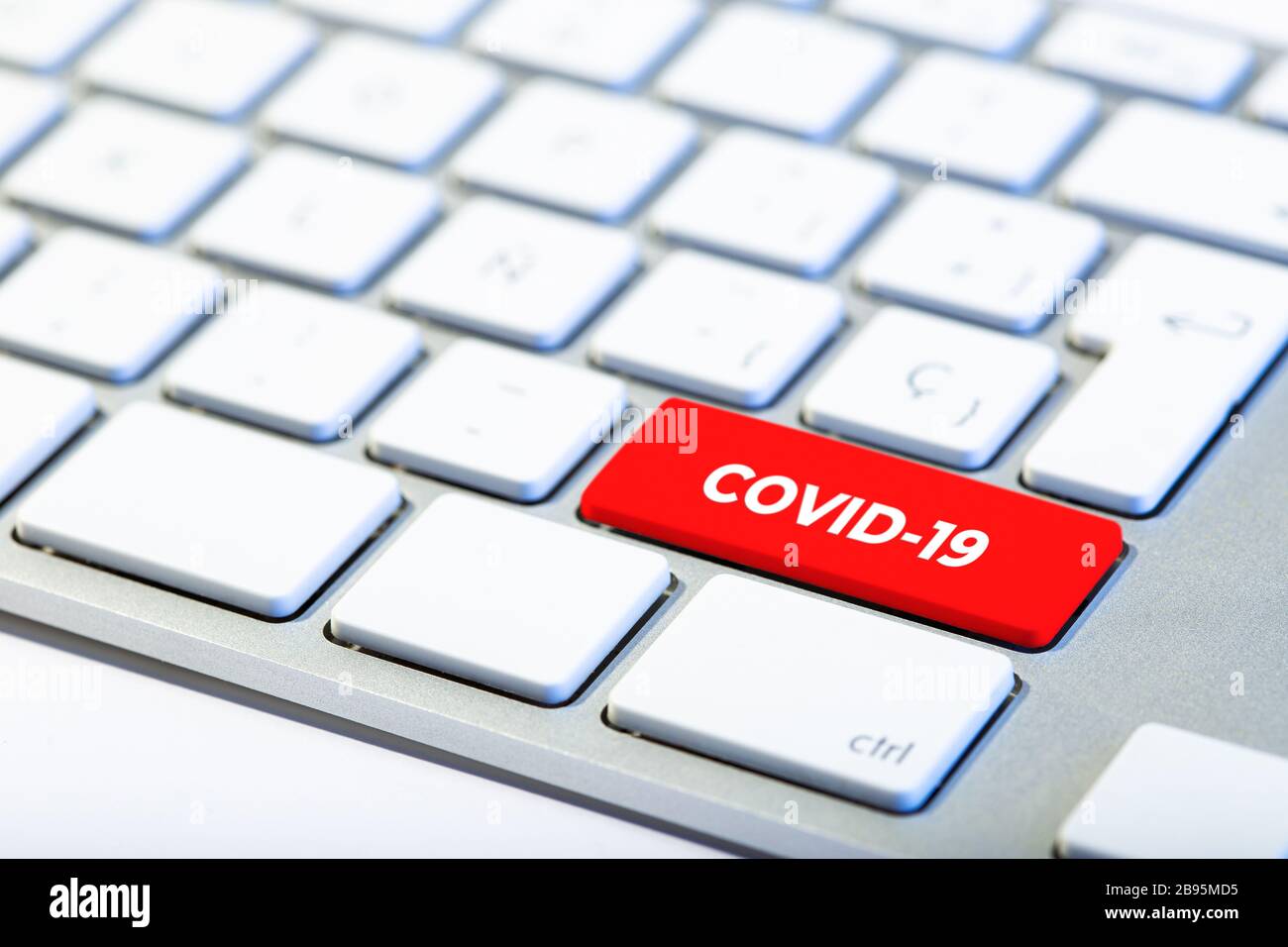 Concept de coronavirus. Clavier avec touche rouge et message COVID-19 Banque D'Images