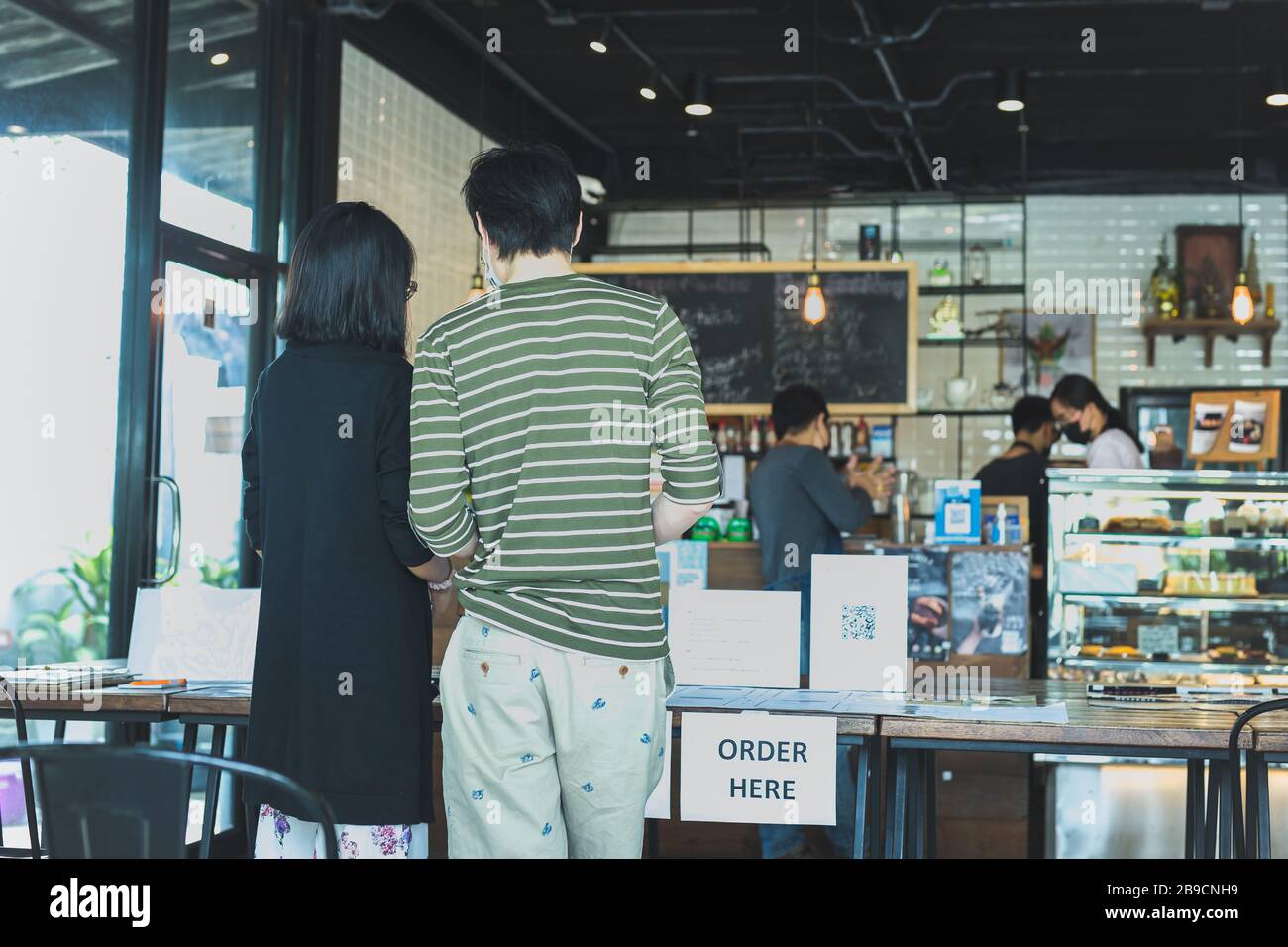 Social distance conceptuel petit serveur d'affaires servant le client au café. Banque D'Images