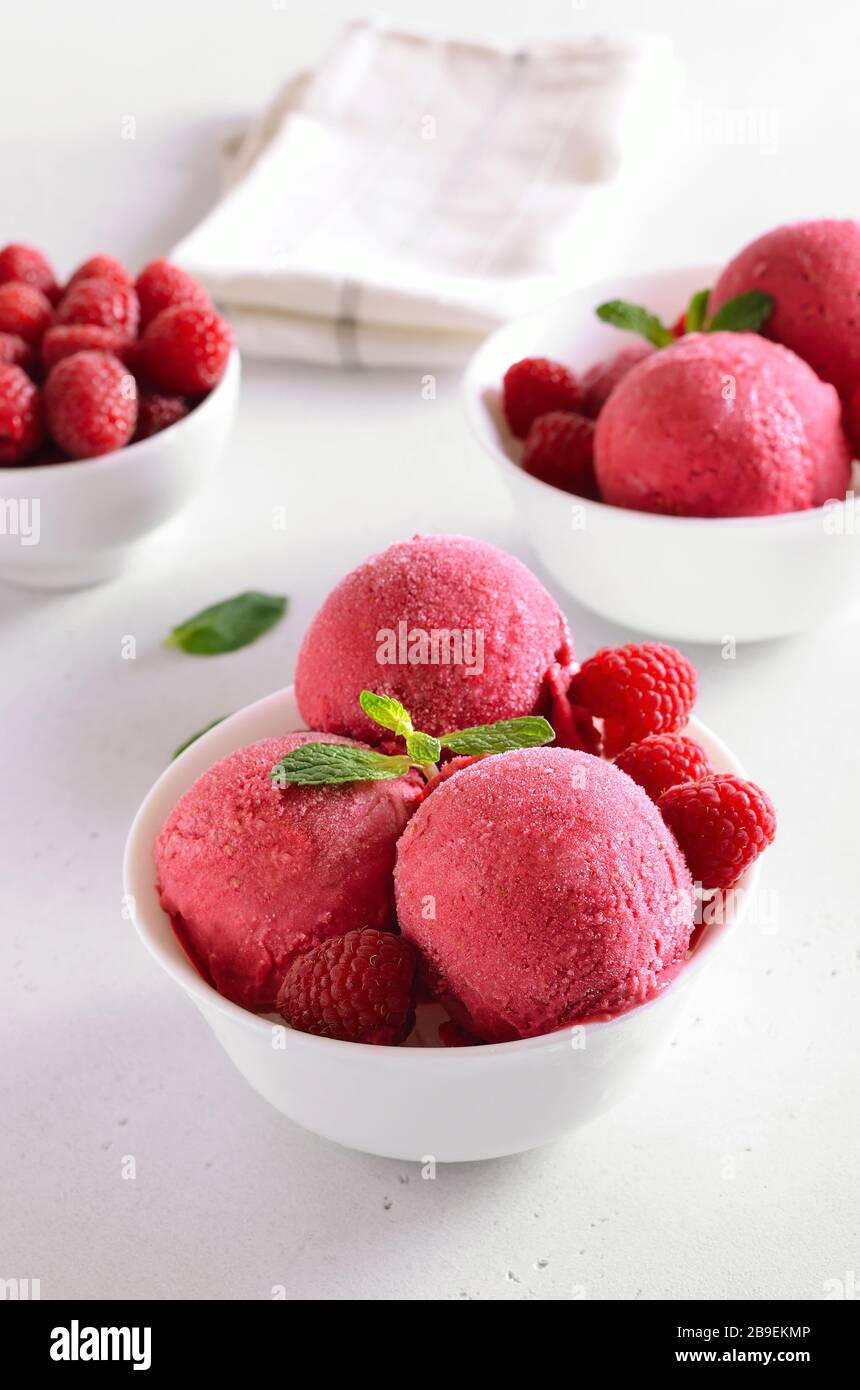 Pelle à glace aux framboises avec framboises fraîches dans un bol sur fond de pierre. Dessert d'été froid Banque D'Images